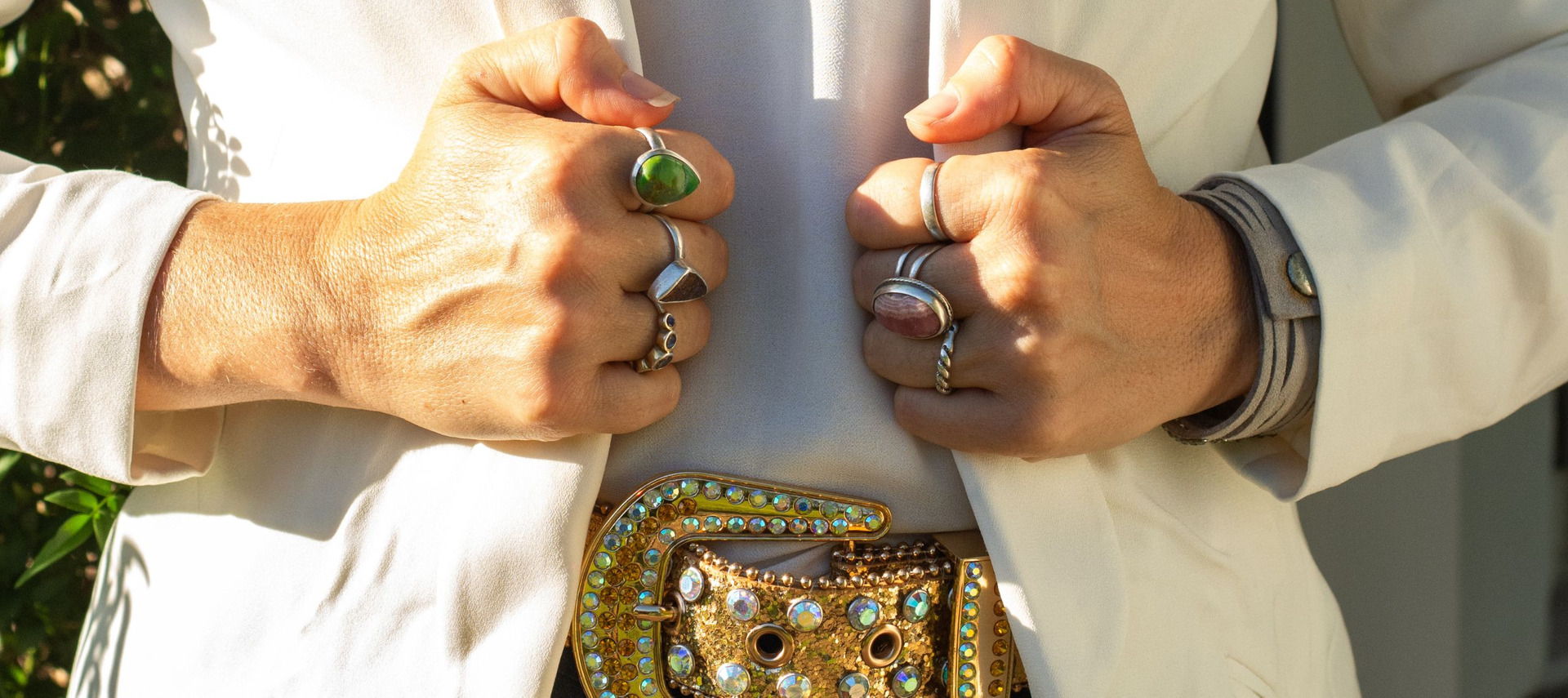 Details of Ro’s rings, cream jacket and colourful belt